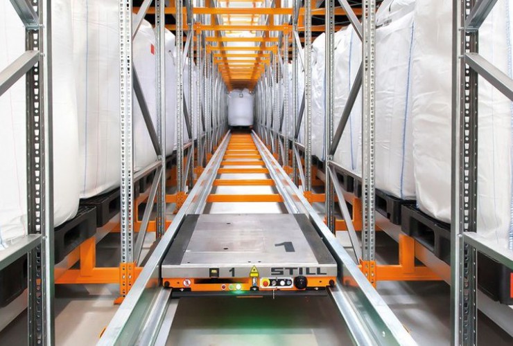 A shuttle retrieves a pallet to supply production.